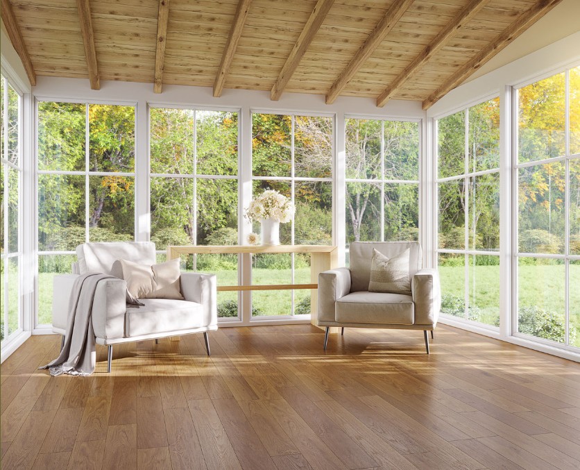 Open space room with wood floors and floor to ceiling windows