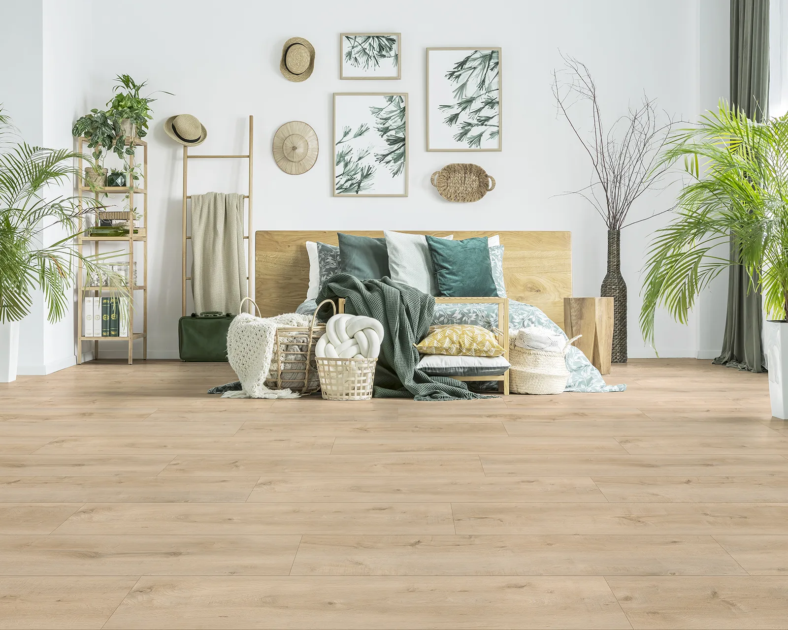 Light colored flooring in bedroom with greenery and wall art