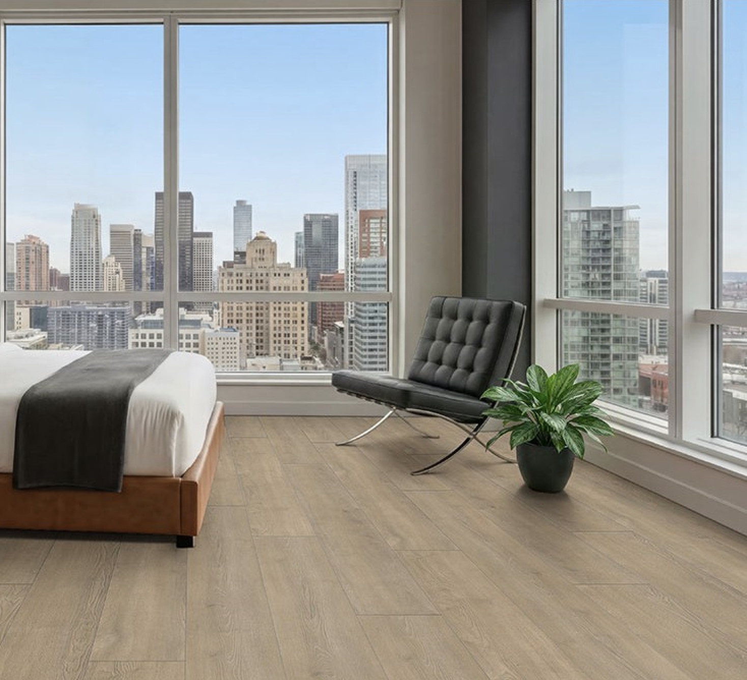 Condo style bedroom with lvp flooring and city background