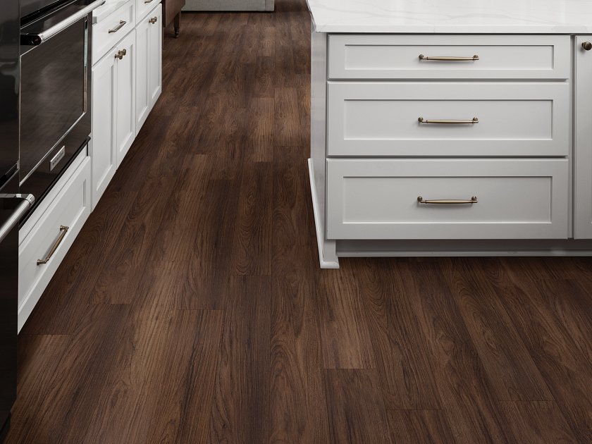 Darker flooring in kitchen with white cabinets