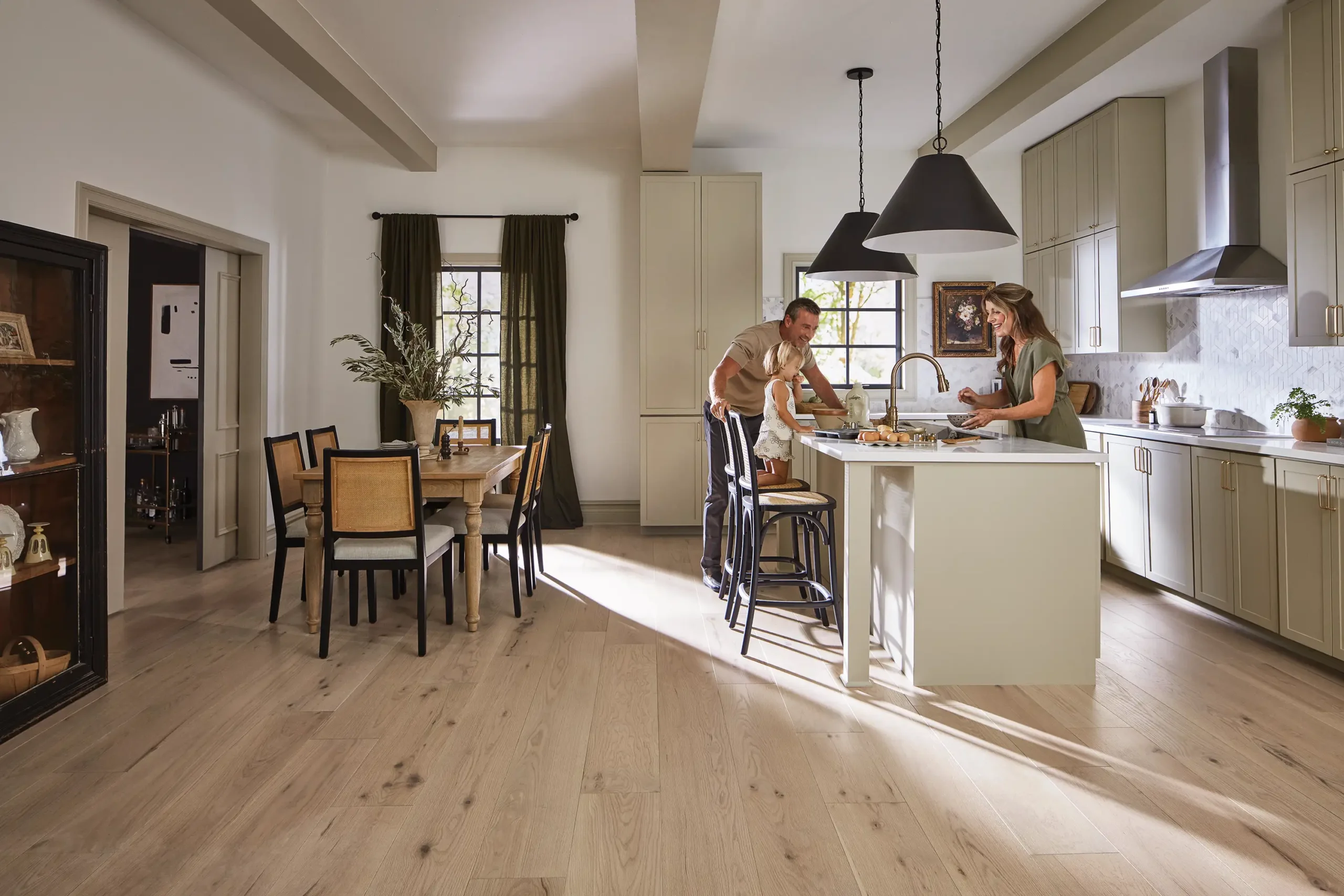 Family gathered around kitchen with new floors by licensed flooring and renovation contractor
